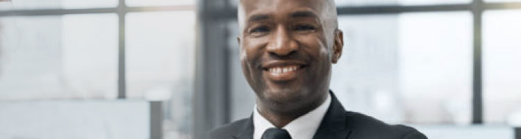 Man in business suit standing and smiling