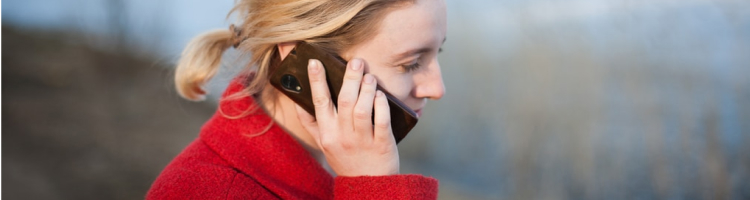 Woman holds cell phone to her ear